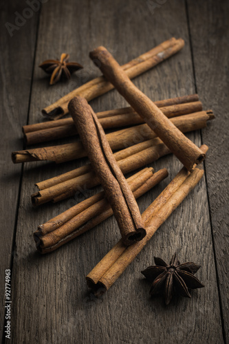 Cinnamon stick and star anise spice on rustic wood table  backgr
