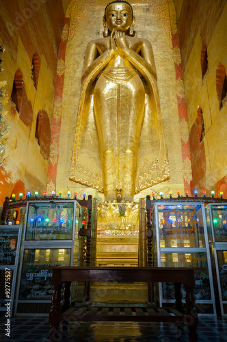 Golden Buddha standing inside of Ananda temple in Bagan. photo