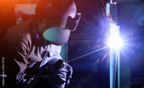 Industrial worker Welding and bright sparks. Hard job © kokotewan