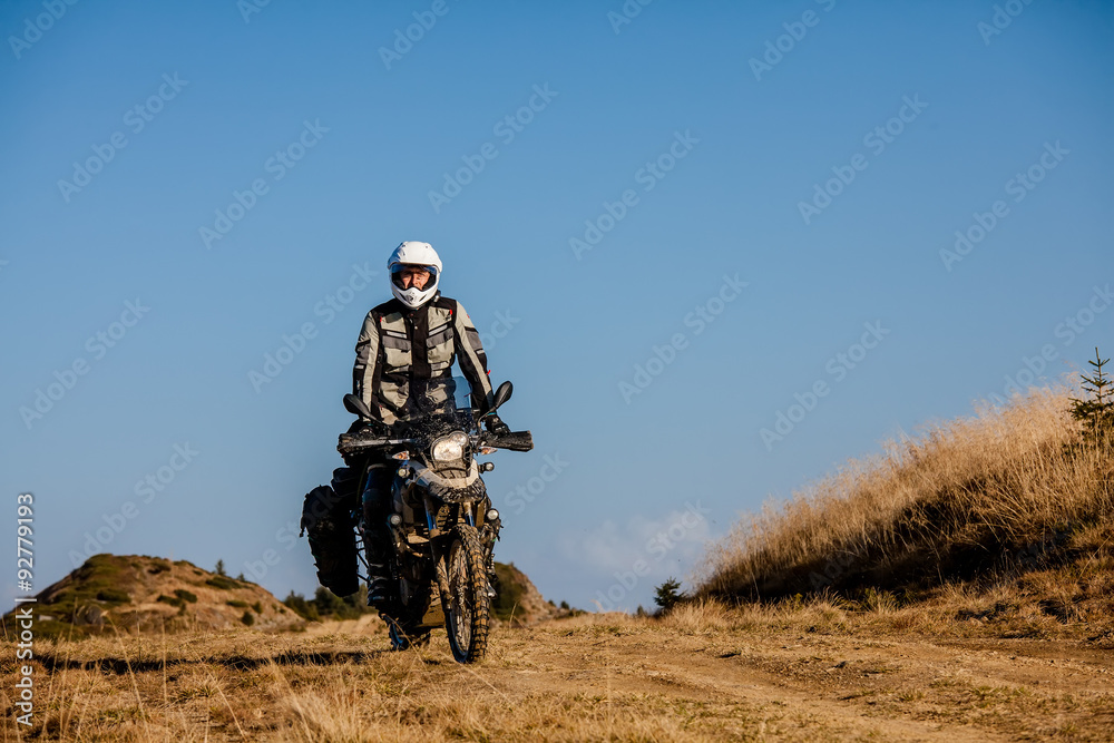 Motorbiker travelling in autumn mountains Motorbiker travelling in autumn mountains
