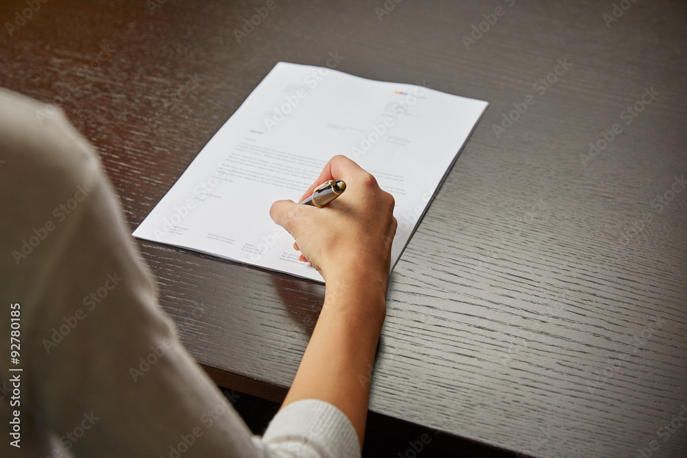 Woman writing on white paper Woman writing on white paper