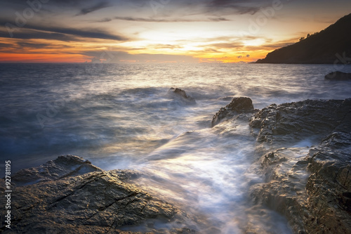 long exposure of sea and rocks and stones, teal tone © arhendrix