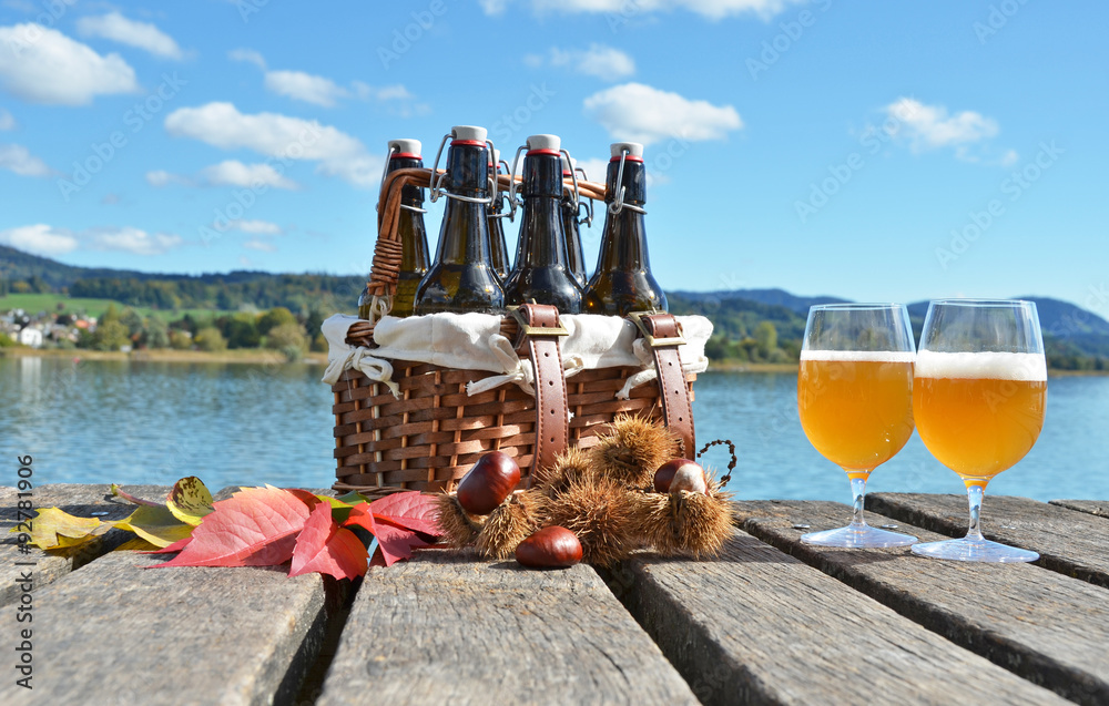 Beer on the wooden jetty against a lake