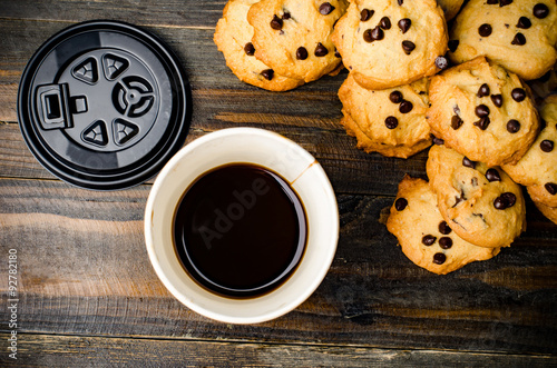 Hot coffee and chocolate chip cookies on wooden background