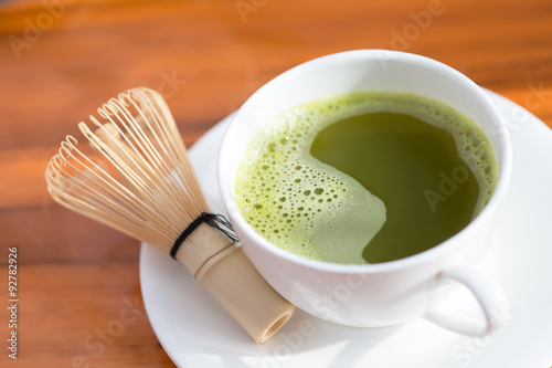 healthy green tea in cup and bamboo whisk