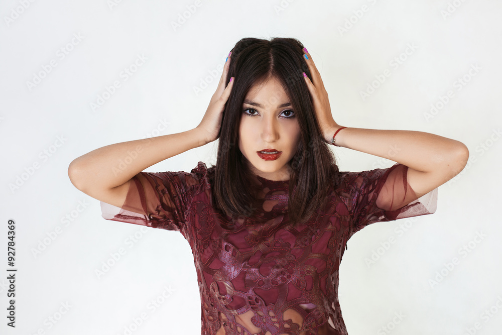 Young cute woman covering her ears isolated on a white background. Looking at camera Young cute woman covering her ears isolated on a white background. Looking at camera
