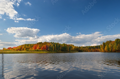 Landscape colorful autumn forest lake river sky clouds