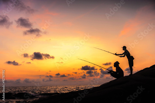 Fisherman on sunset photo