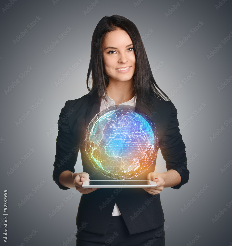 Smiling Girl holding digital globe over tablet Smiling Girl holding digital globe over tablet