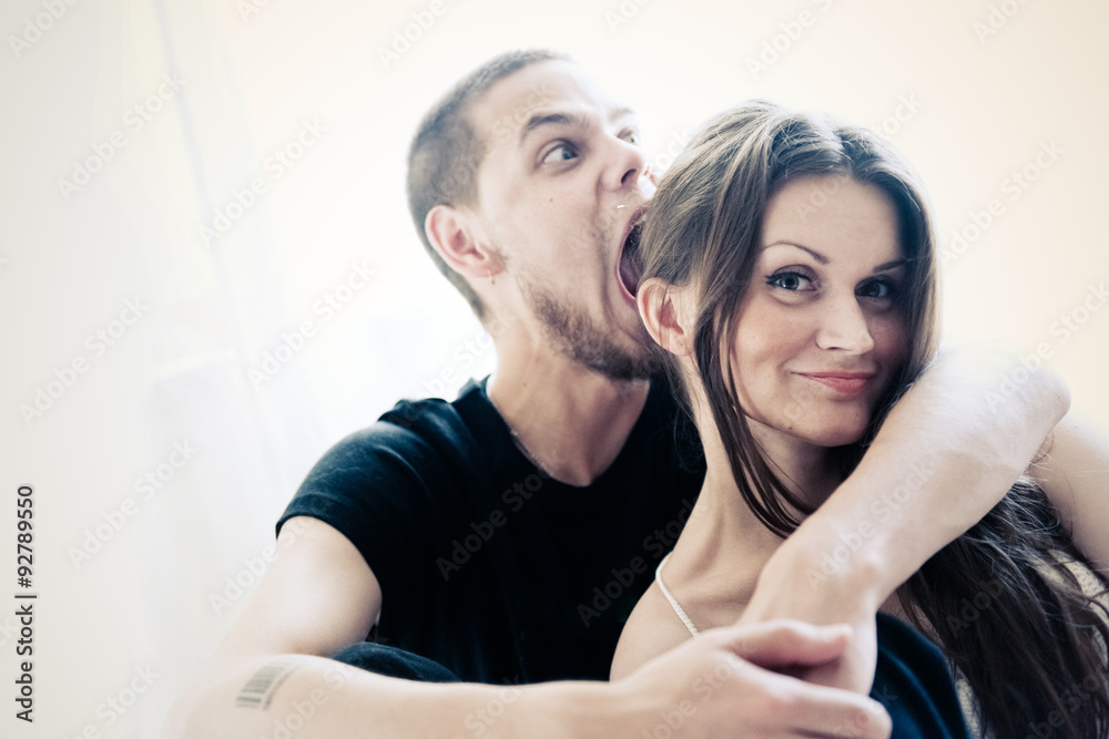 Fototapeta premium Portrait of a happy young couple having fun on the bed