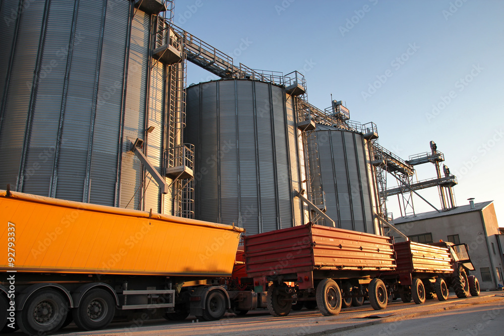 Tractor and Truck Beside Grain Silos Tractor and Truck Beside Grain Silos