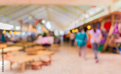 Blurred image of people walking at day market