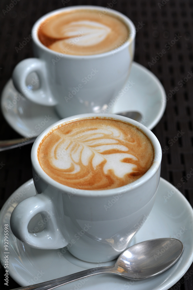 White Cup Of Foamy Cappuccino On A Black Background White Cup Of Foamy Cappuccino On A Black Background