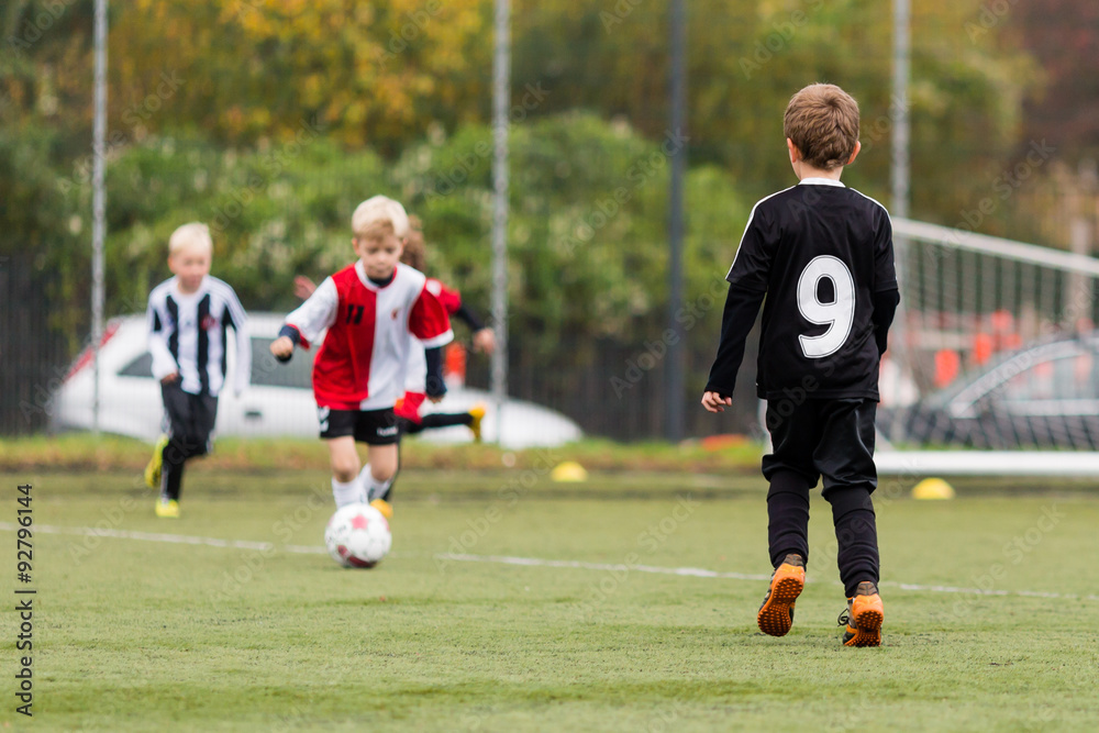 Three boys playing soccer