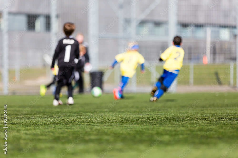 Obraz premium Blurred Kids Playing Soccer