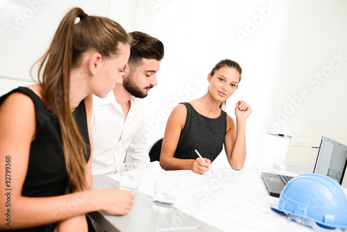 group of construction business people and architect discussing with blueprint in an office meeting room
