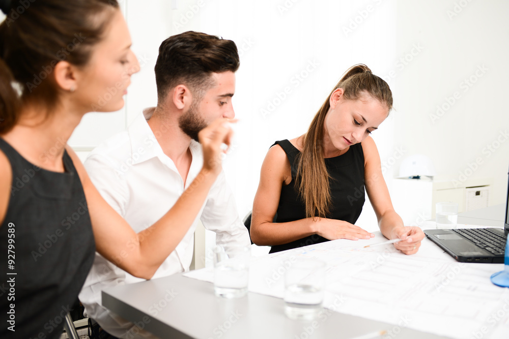 group of construction business people and architect discussing with blueprint in an office meeting room group of construction business people and architect discussing with blueprint in an office meeting room