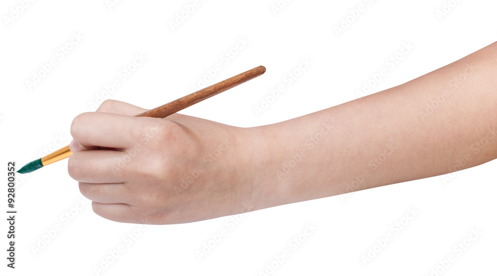 hand holds artistic paint brush with green tip hand holds artistic paint brush with green tip