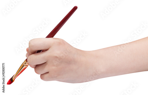 hand holds artistic flat paintbrush with red tip