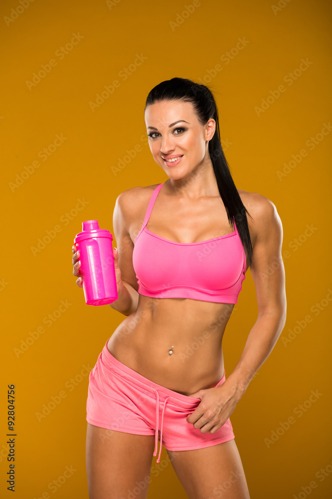 beautiful fitness model on a yellow background beautiful fitness model on a yellow background