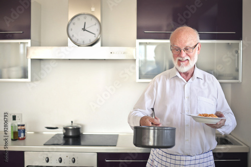 Elderly man cooking pasta