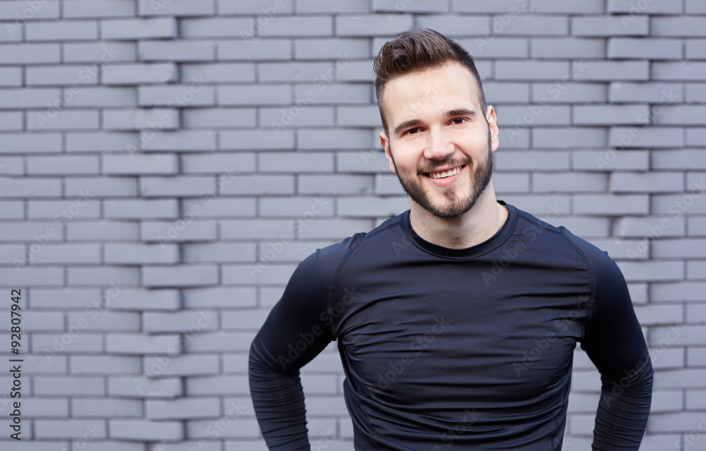 Portrait of smiling man resting after workout outdoors, fit cauc Portrait of smiling man resting after workout outdoors, fit cauc