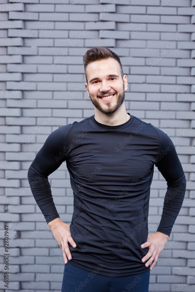 Portrait of smiling man resting after workout outdoors, fit cauc Portrait of smiling man resting after workout outdoors, fit cauc