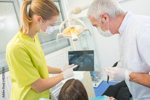 Busy dentist with a patient
