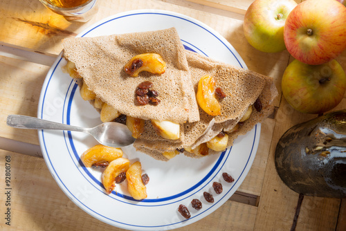 Apple pancakes with a bottle and a glass of cider photo