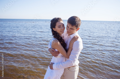 Just married happy bride and groom, young couple embraces on the