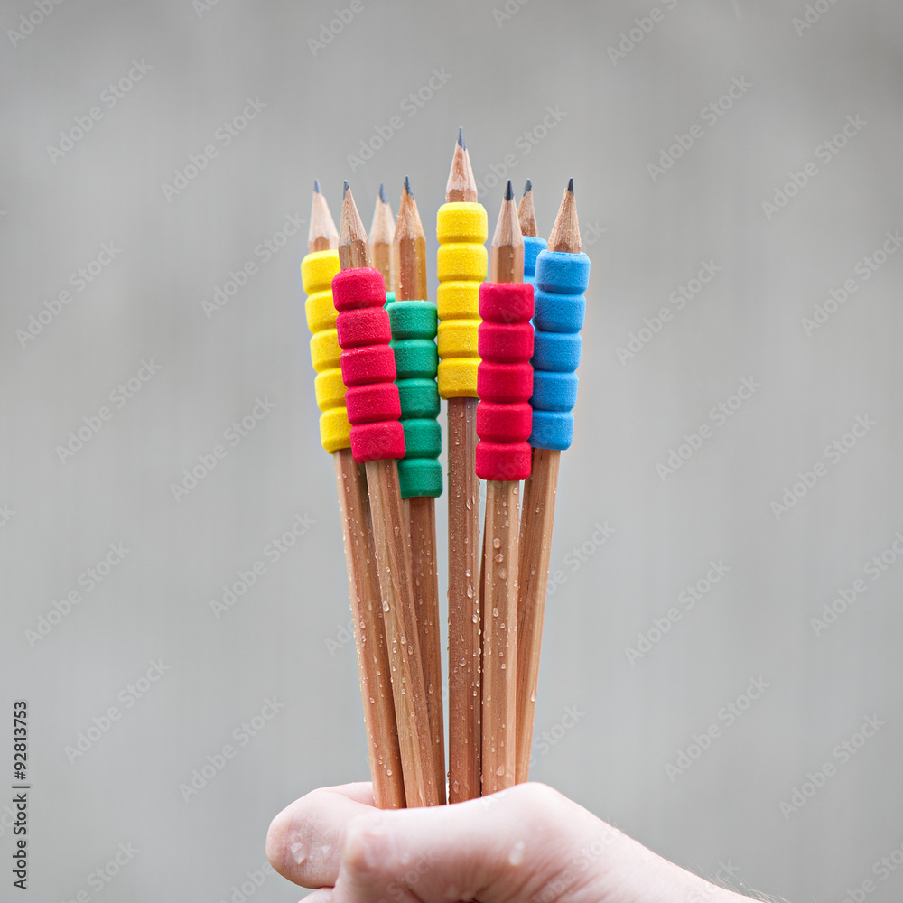 Row of color pencils on grey background.Studio shot Row of color pencils on grey background.Studio shot