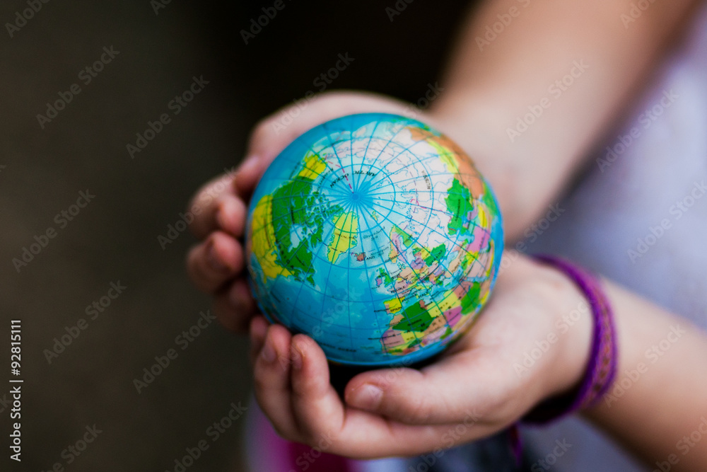 Little girl holding the earth in her hands. Earth day. Green concept Little girl holding the earth in her hands. Earth day. Green concept