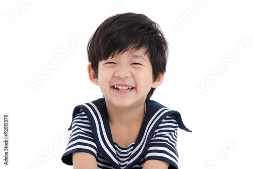 Happy asian boy sitting on white background