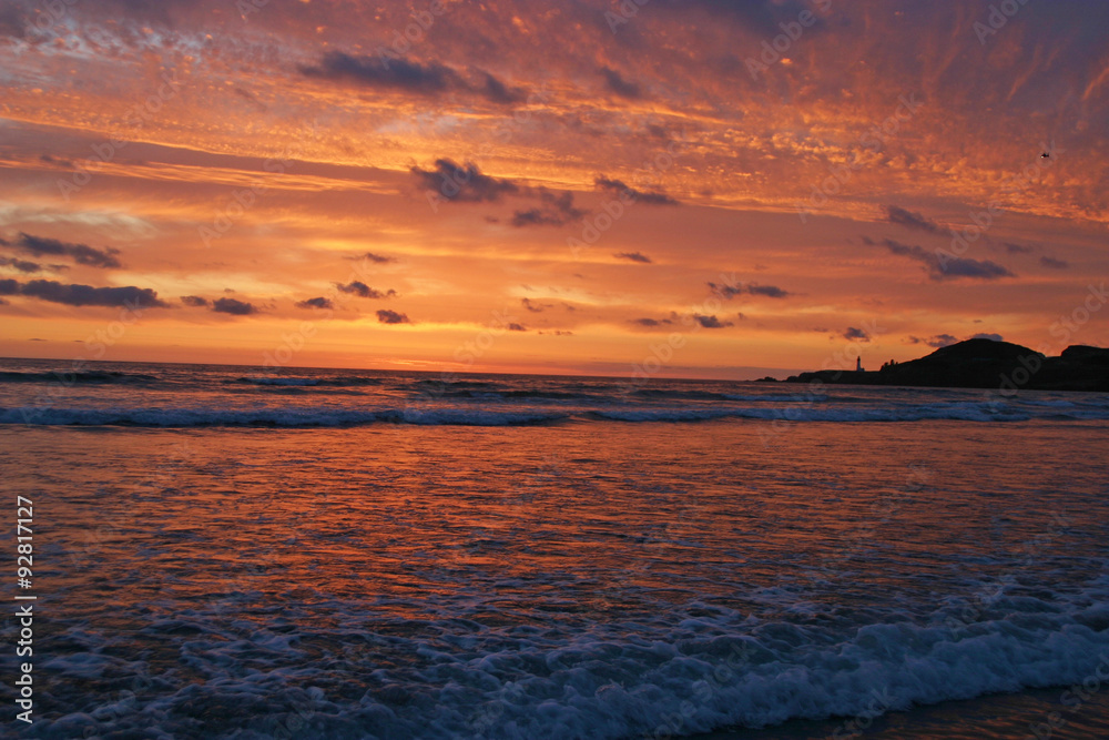 Glorious sunset Over Lighthouse and Sea Glorious sunset Over Lighthouse and Sea