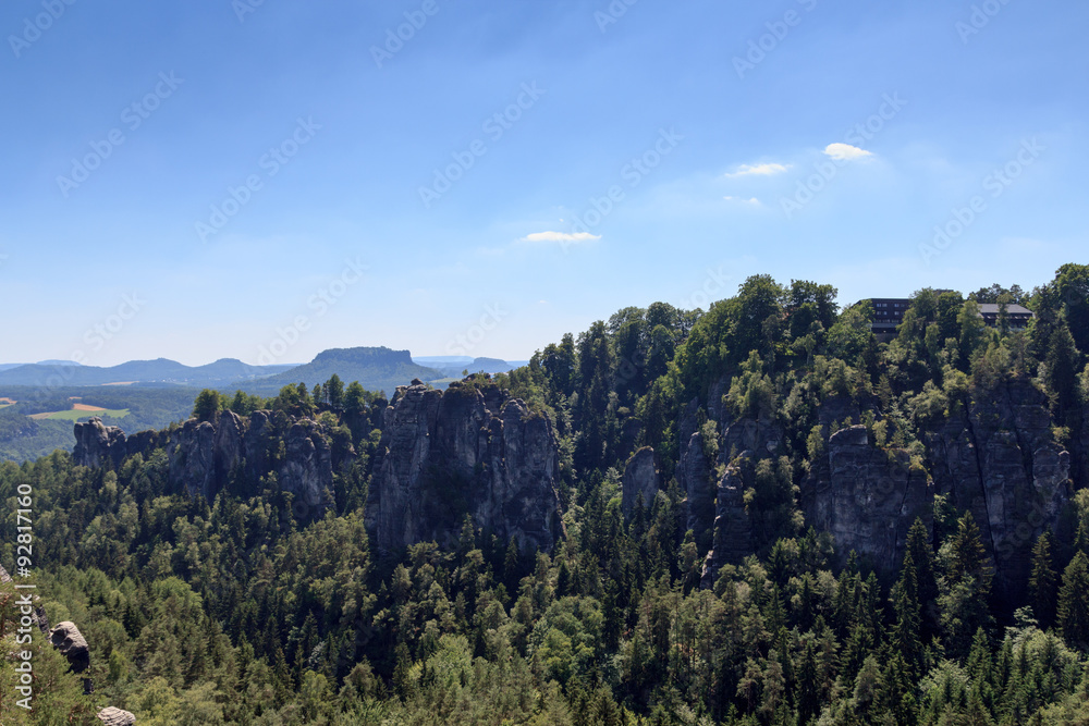 Panorama with rocks Bastei, table mountain Lilienstein and hotel in Rathen, Saxon Switzerland