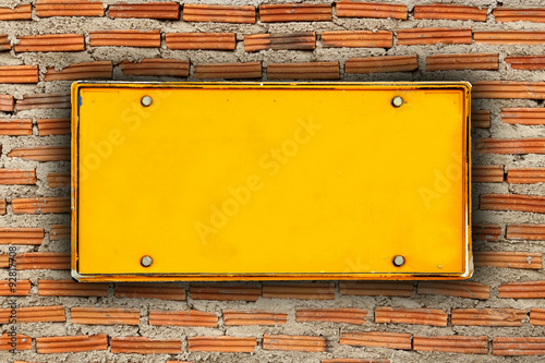 blank license plate on brick wall background