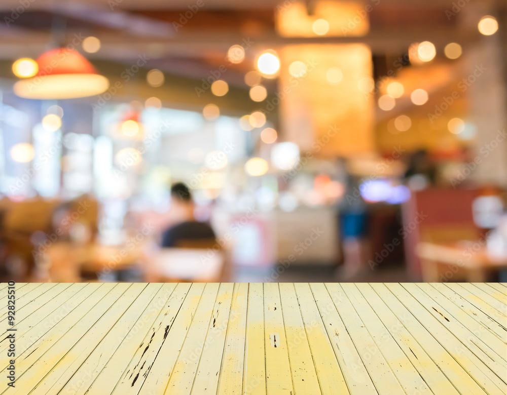Empty wood table and Coffee shop blur background with bokeh imag Empty wood table and Coffee shop blur background with bokeh imag