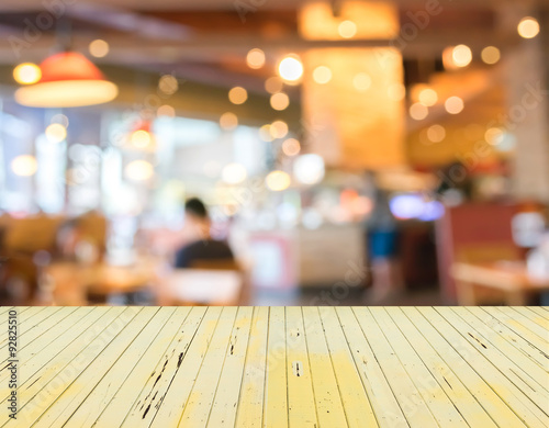 Empty wood table and Coffee shop blur background with bokeh imag