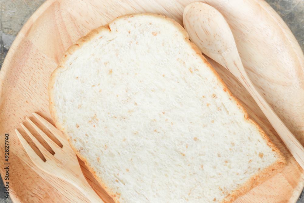 Sliced of whole wheat bread on wooden plate Sliced of whole wheat bread on wooden plate