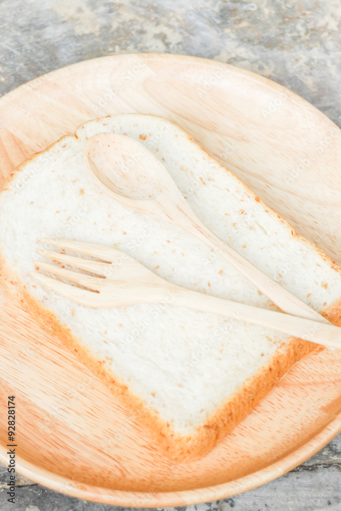 Sliced of whole wheat bread on wooden plate Sliced of whole wheat bread on wooden plate