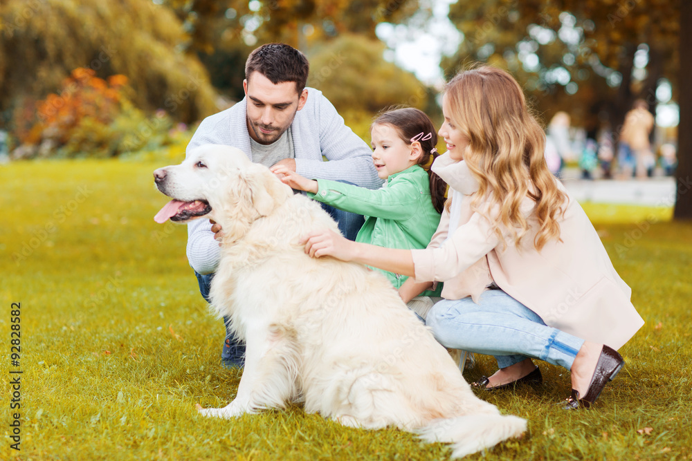 Fototapeta premium happy family with labrador retriever dog in park