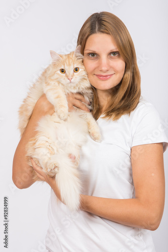 Girl hugging domestic cat