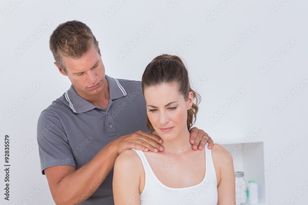 Doctor examining his patient neck Doctor examining his patient neck