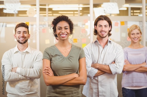 Portrait of smiling business team with arms crossed in office