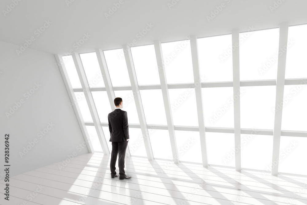 Fototapeta premium Businessman in the white loft interior