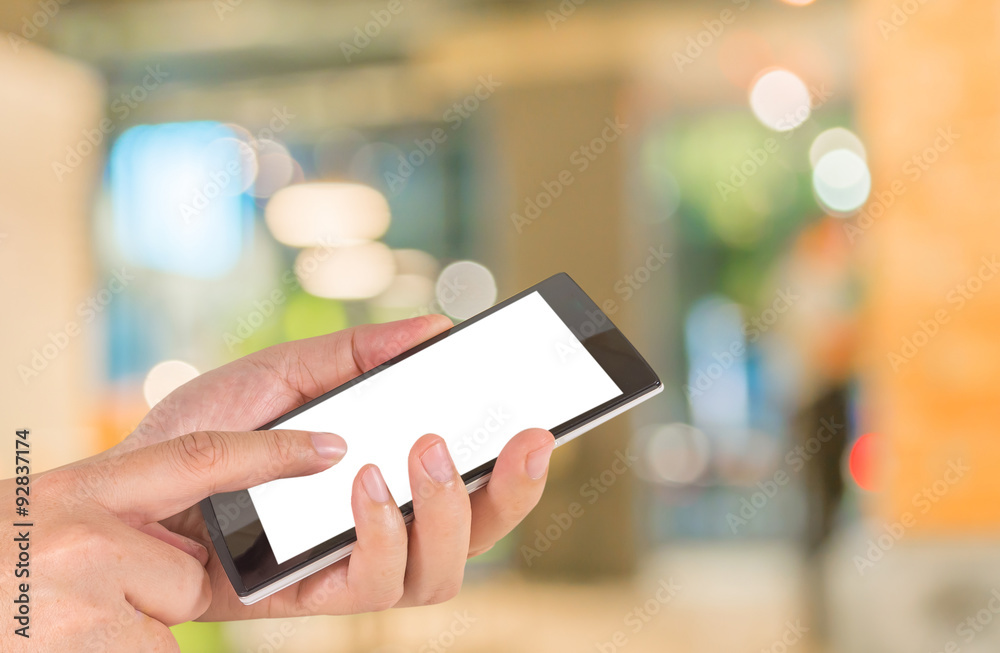 male hand is holding a modern touch screen phone and Coffee shop