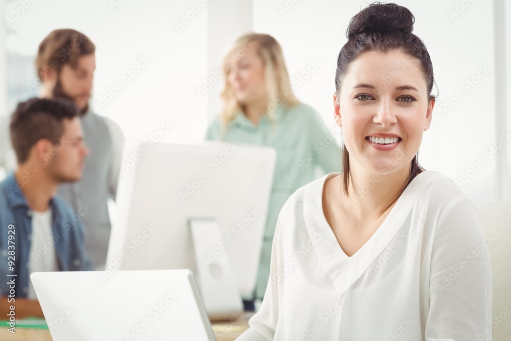 Portrait of smiling businesswoman working on laptop Portrait of smiling businesswoman working on laptop