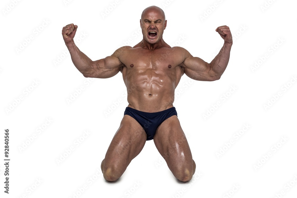 Aggressive man kneeling down with arms outstretched