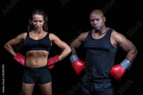Portrait of male and female boxers with hands on hip © WavebreakmediaMicro