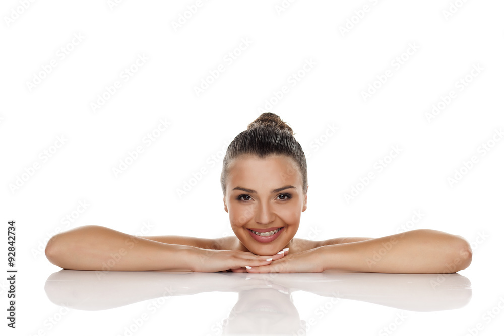 sensual young woman with a bun lying on her hands sensual young woman with a bun lying on her hands